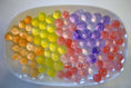Load image into Gallery viewer, Colorful display of Marbled Vein Water Beads arranged in a decorative tray for sensory play and vibrant decor.