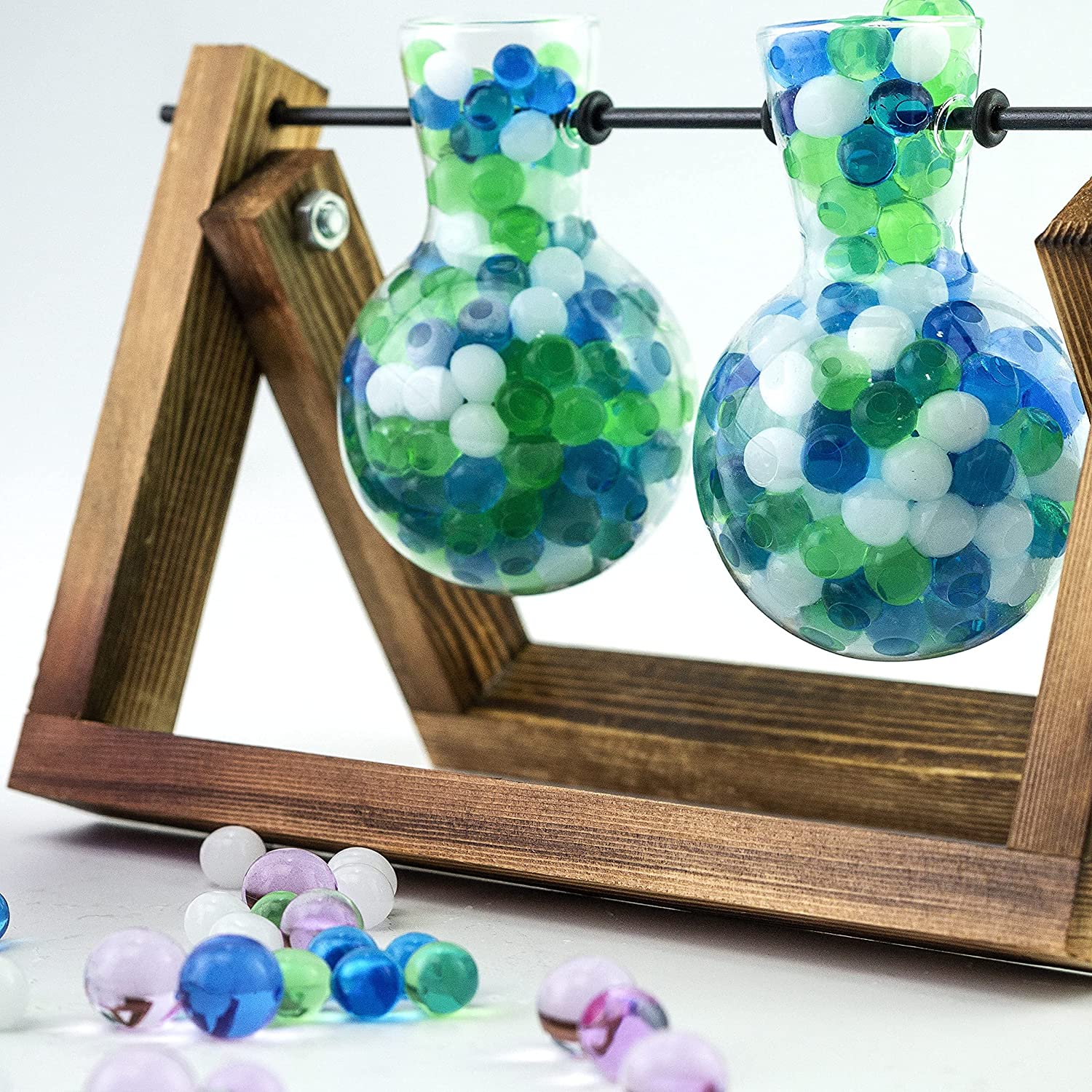 Mixed blue, white, and turquoise decorative water gel beads in a glass vase, perfect for ocean-themed event centerpieces.