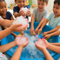 Load image into Gallery viewer, Children engaging with Super Absorbent Diaper Polymer in a colorful play area while exploring science.
