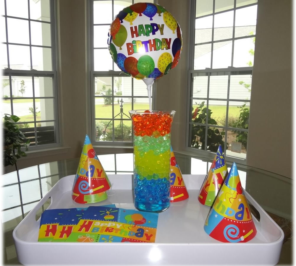 Cosmo Beads Multi-Color Water Beads displayed in a festive birthday setup with balloons and party hats.
