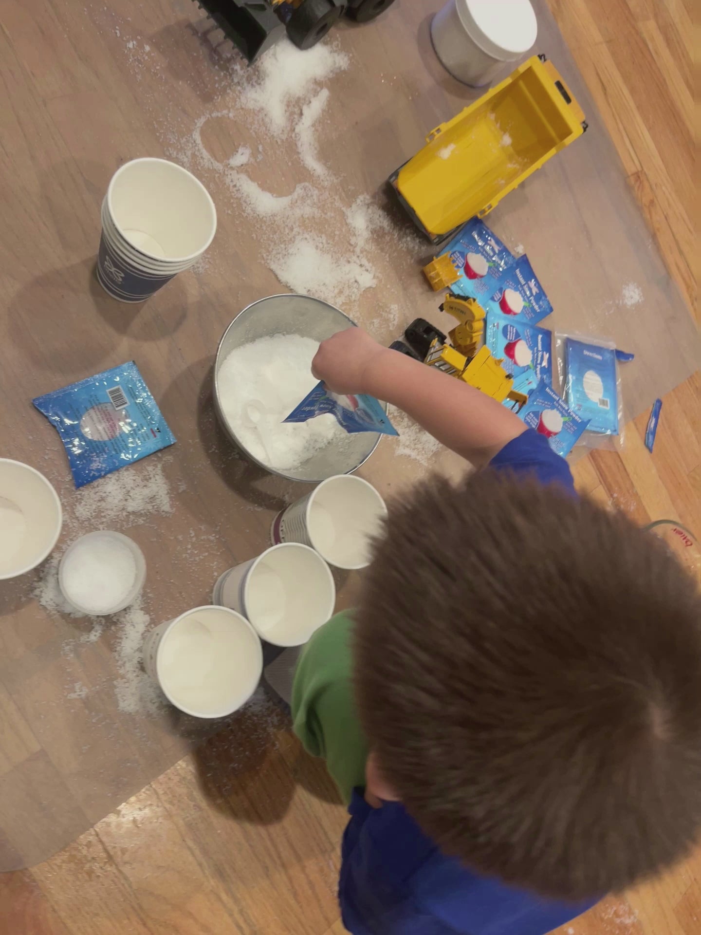 Science experiment video showing how to mix water and fake snow in cups
